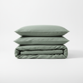 Minimalist sage green linen duvet cover set on white background
