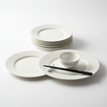 Set of 4 matte white ceramic dinner plates on white background